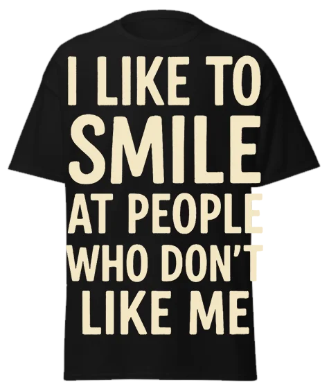Black unisex t-shirt with off-white text reading "I LIKE TO SMILE AT PEOPLE WHO DON'T LIKE ME" – funny sarcastic graphic tee